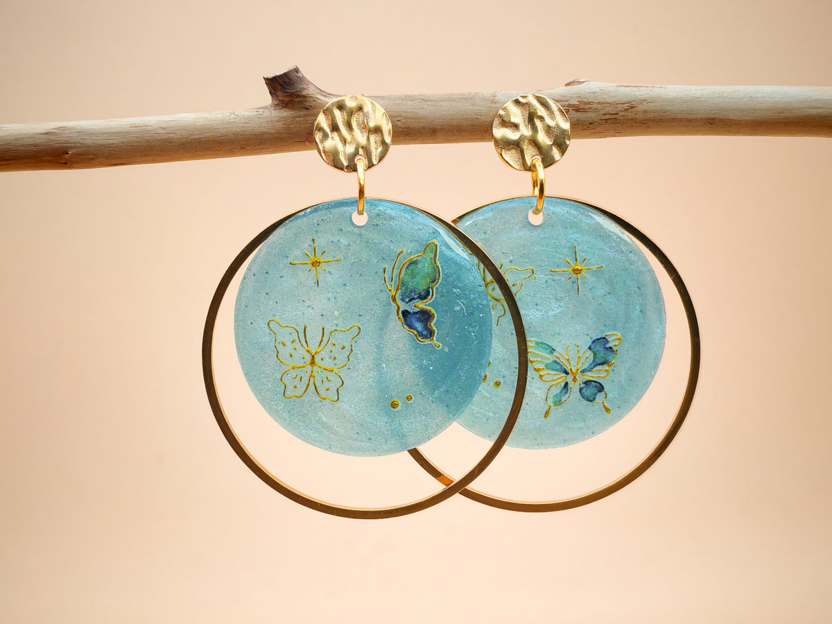 Boucles d’oreilles – Papillons dorés sur ciel givré